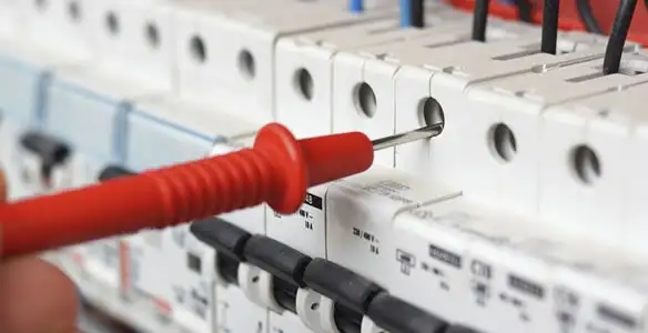 Electrical contractor testing circuit breakers during electrical repair in Decatur, GA