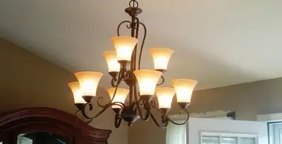 Classic ceiling chandelier installation with warm lighting in Atlanta, GA