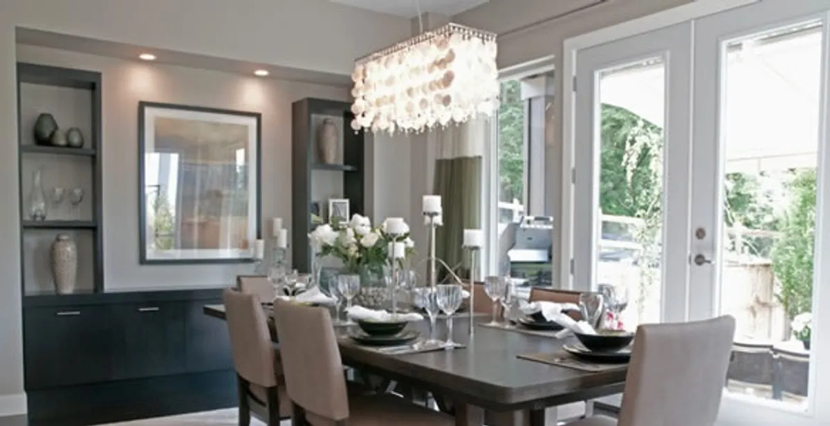 Elegant dining room chandelier installation above table in Atlanta, GA