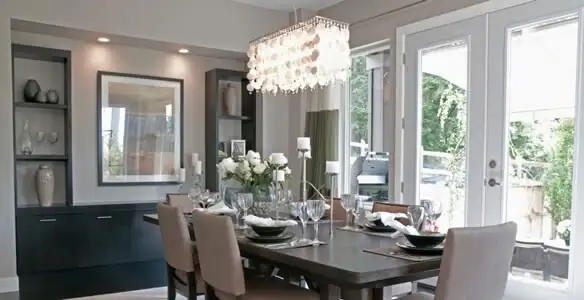 Elegant dining room chandelier installation above table in Atlanta, GA