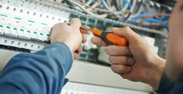 electrical service showing licensed electrician performing electrical panel maintenance and adjustments in Atlanta, GA