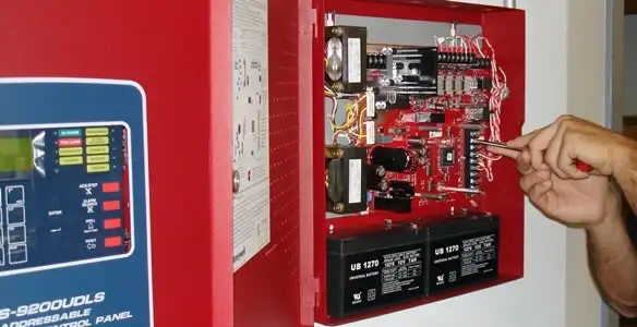 fire alarm installation service showing technician configuring fire alarm control panel in Atlanta, GA