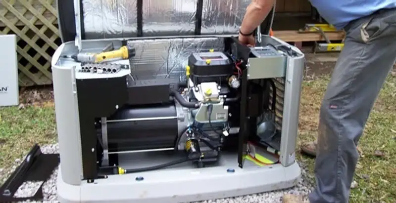 generator installation service showing technician connecting and configuring generator components in Atlanta, GA
