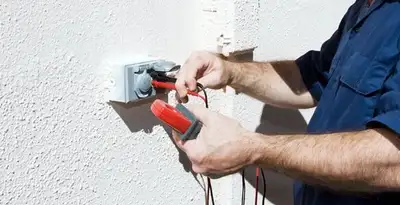 Electrician performing home electrical outlet and wiring inspection in Atlanta, GA