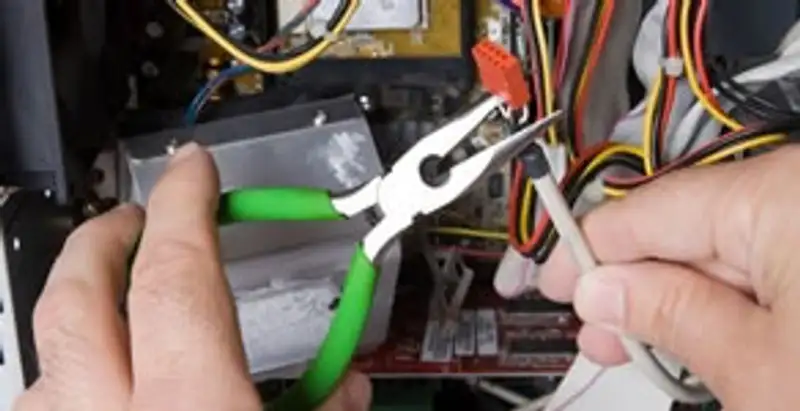 Licensed electrical contractor performing electrical repair with tools in Conley, GA