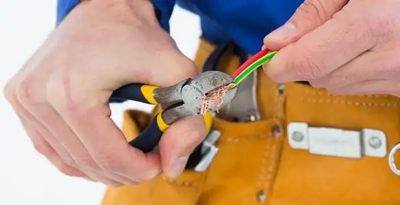 licensed electrician securing electrical wiring with professional tools during service work in Atlanta, GA