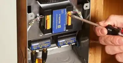 Whole home surge protection device being installed by a licensed electrician to protect electrical systems in Atlanta, GA